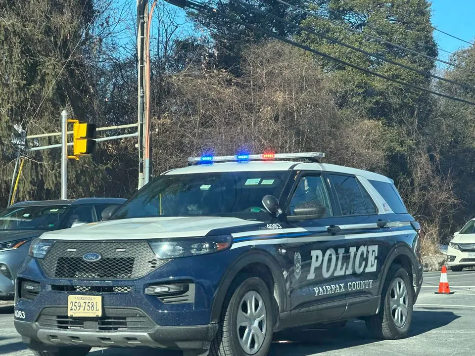 A Fairfax County Police Department SUV with red and blue lights flashing (staff photo by Angela Woolsey)