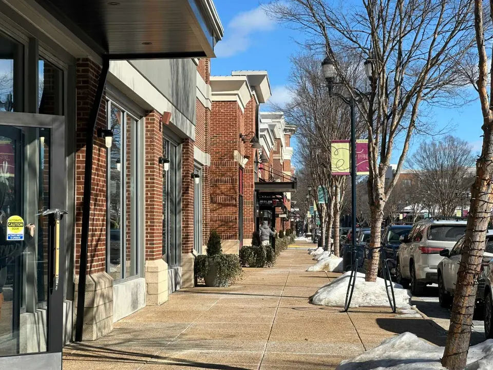 Doors open along the Grand Commons Avenue sidewalk in Fairfax Corner (staff photo by Angela Woolsey)