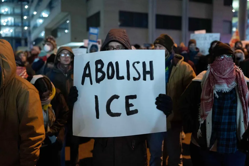 A demonstrator holds a sign during a rally outside of U.S. Immigration and Customs Enforcement headquarters in Washington, Saturday, Jan. 24, 2026. (AP Photo/Jose Luis Magana)