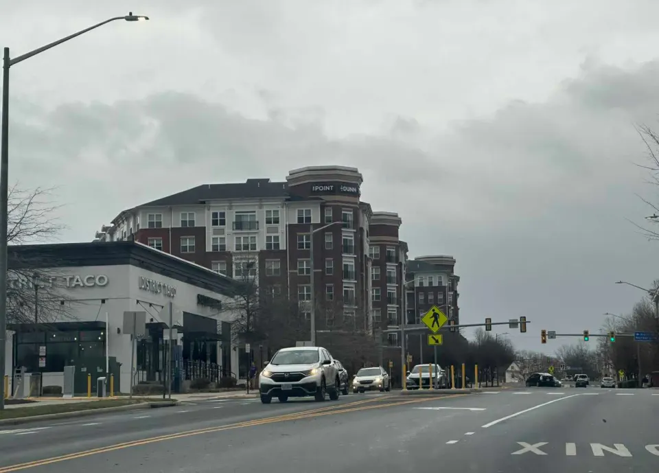 Cars pass District Taco on Prosperity Avenue near the Dunn Loring Metro station (staff photo by Angela Woolsey)