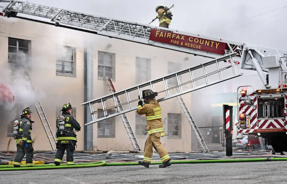Firefighters work to extinguish a building fire in the 5600 block of Leesburg Pike in Bailey’s Crossroads on March 13, 2025 (photo by Gerald Martineau)