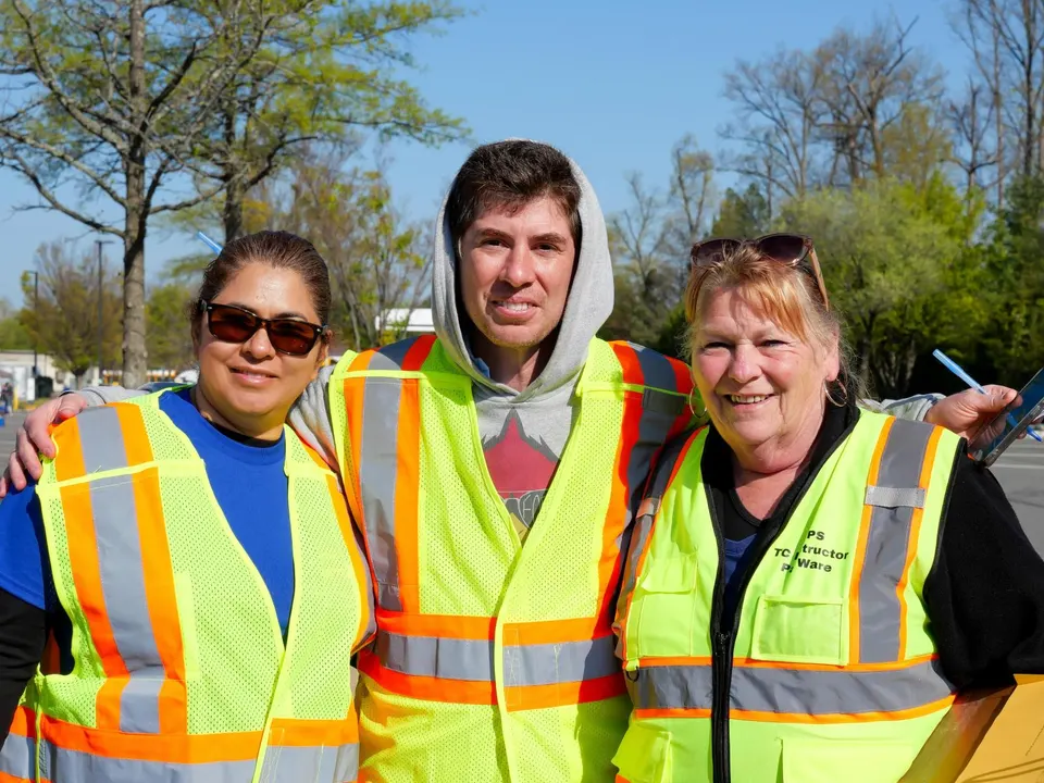 transportation staff smile for a photo