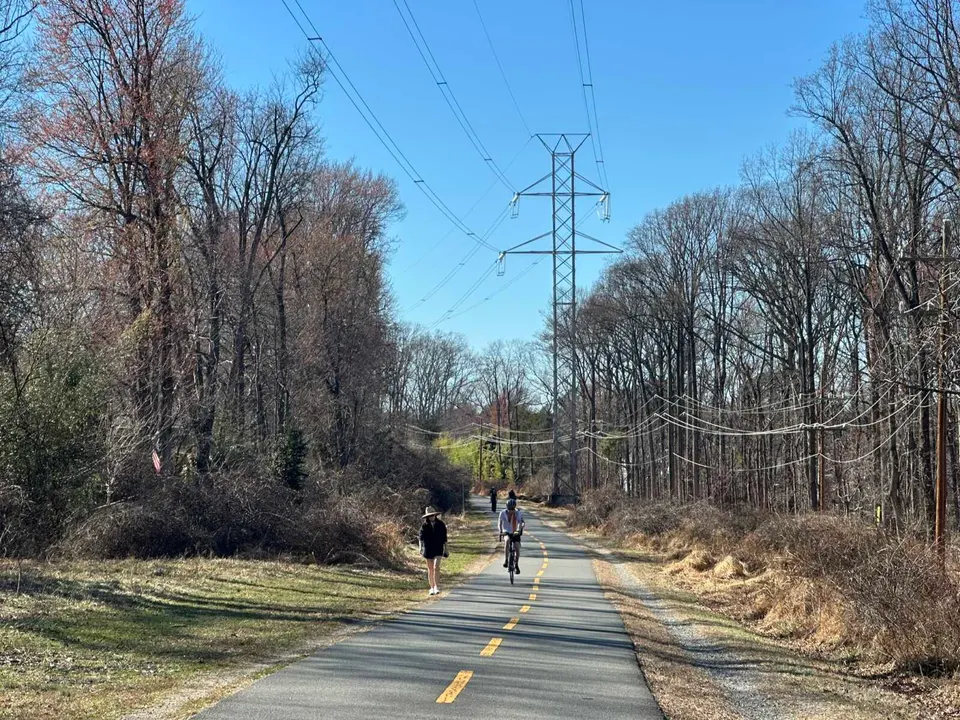 People walk and bike on the W&OD Trail in Vienna on a warm early March afternoon (staff photo by Angela Woolsey)