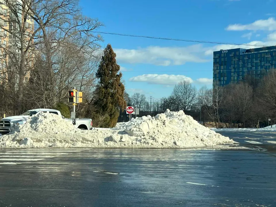 Snow piled around a pedestrian signal refuge for the Reston Parkway and Sunset Hills Road intersection (staff photo by Angela Woolsey)