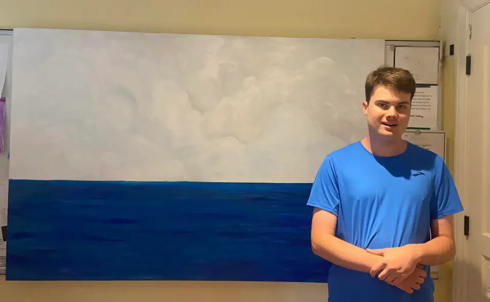 "Blue brings me peace." Michael Lindsay with one of his blue-themed paintings. Courtesy FCA.