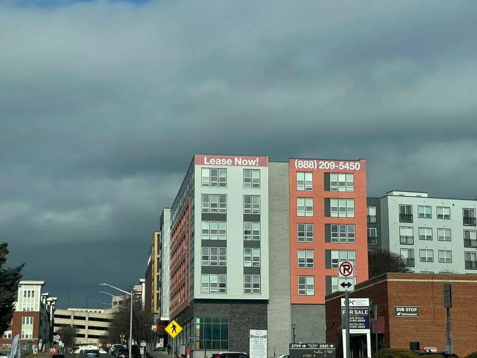 A sign advertises leasing for the Halstead Square apartments near the Dunn Loring Metro station in Merrifield (staff photo by Angela Woolsey)