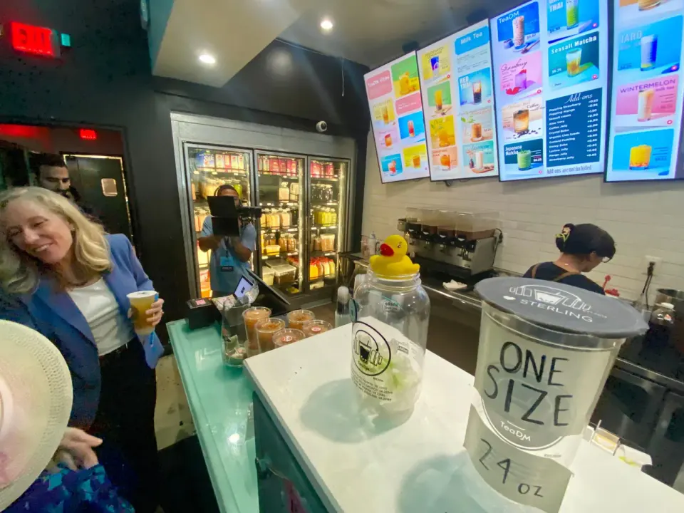 Spanberger greets a well-wisher while sampling the boba tea. Photo by Chris Jones.