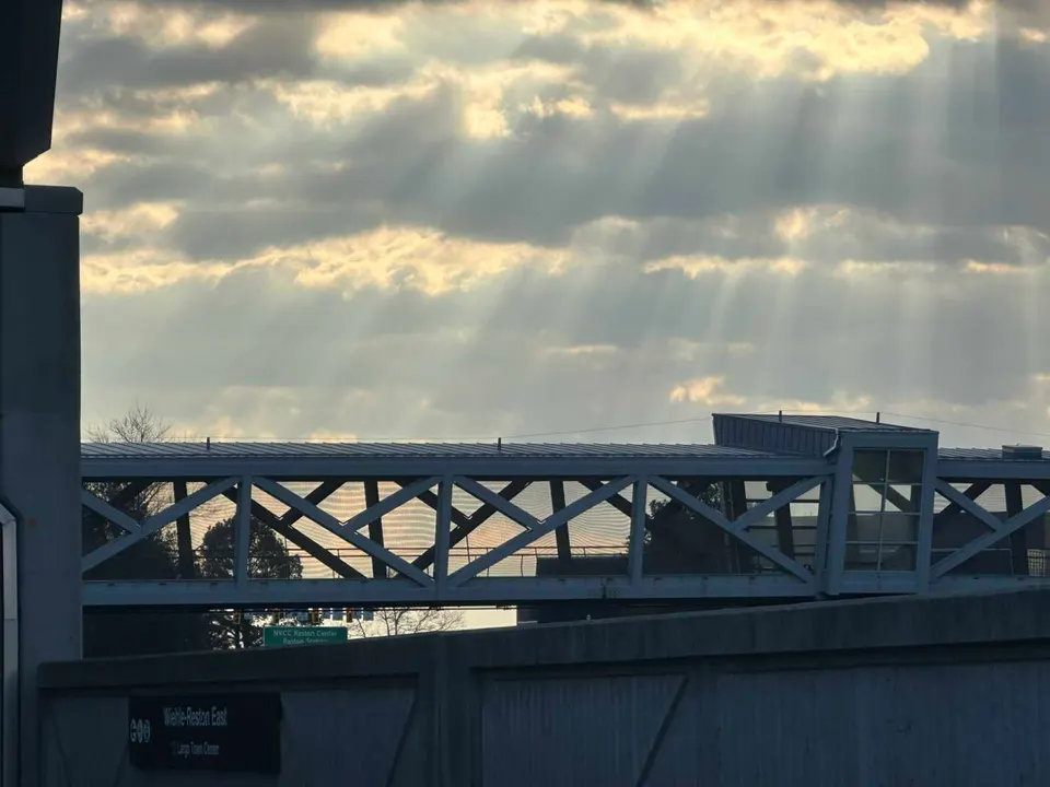 Sun beams shine on the pedestrian walkway to the Wiehle-Reston East Metro station (staff photo by Angela Woolsey)