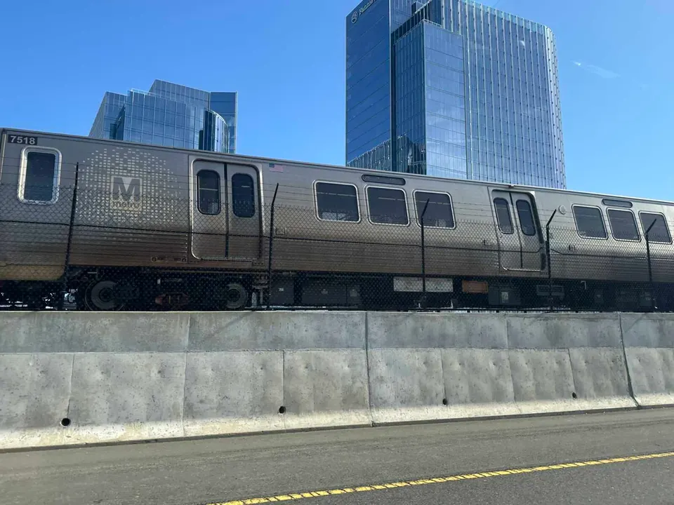 A train on Metro’s Silver Line passing the office buildings in Reston Town Center’s expansion (staff photo by Angela Woolsey)