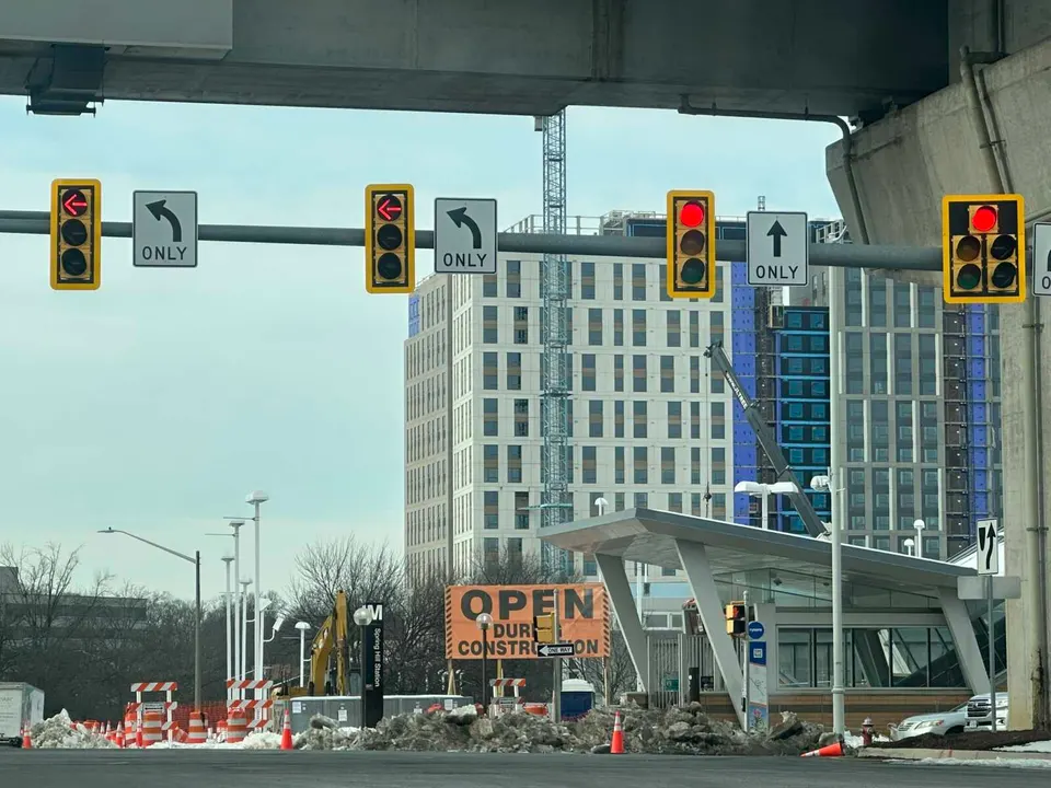 The Exchange at Spring Hill Station under construction in February 2026 behind the Spring Hill Metro station in Tysons (staff photo by Angela Woolsey)