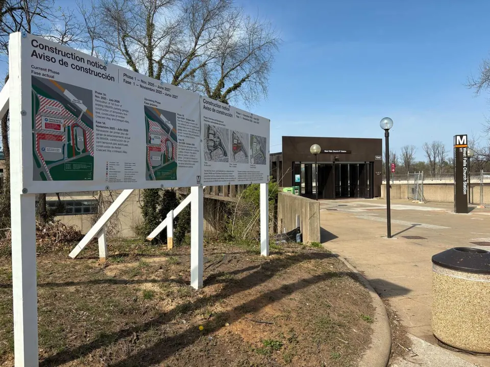 A notice outside the West Falls Church Metro station for construction on new roads, bus facilities and a parking garage renovation (staff photo by Jared Serre)