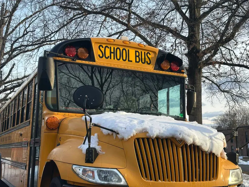Snow on the hood of a Fairfax County school bus (staff photo by Angela Woolsey)