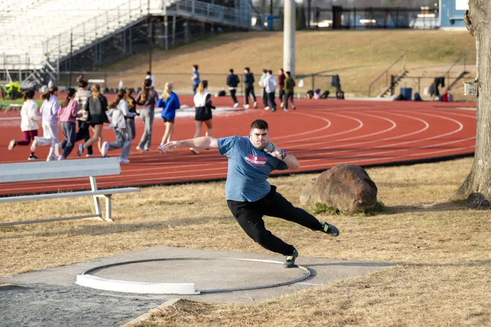 Woodson High School senior Barrett Pullen practices throwing the shot put.