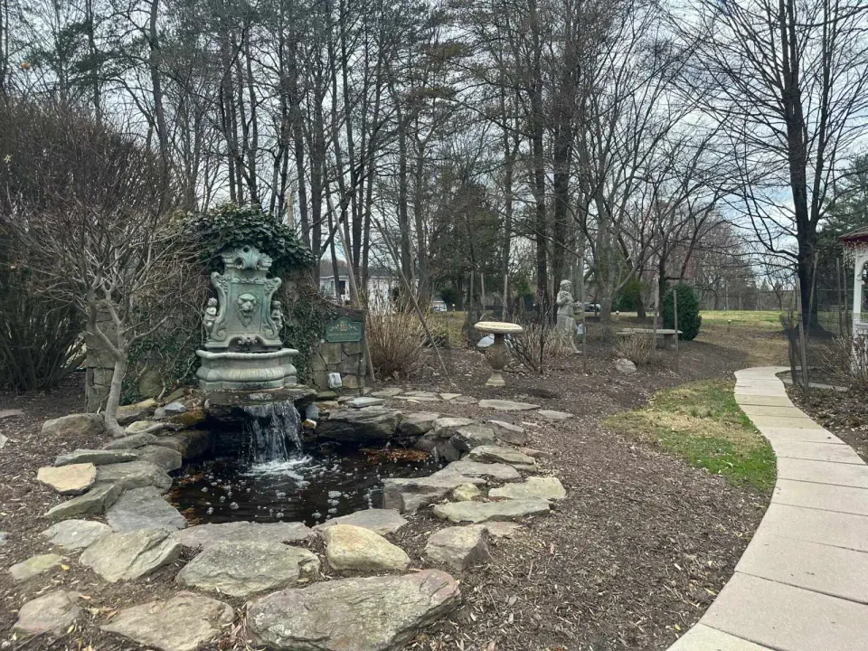 A water fountain and walking path behind L’Auberge Chez Francois in Great Falls (staff photo by Angela Woolsey)